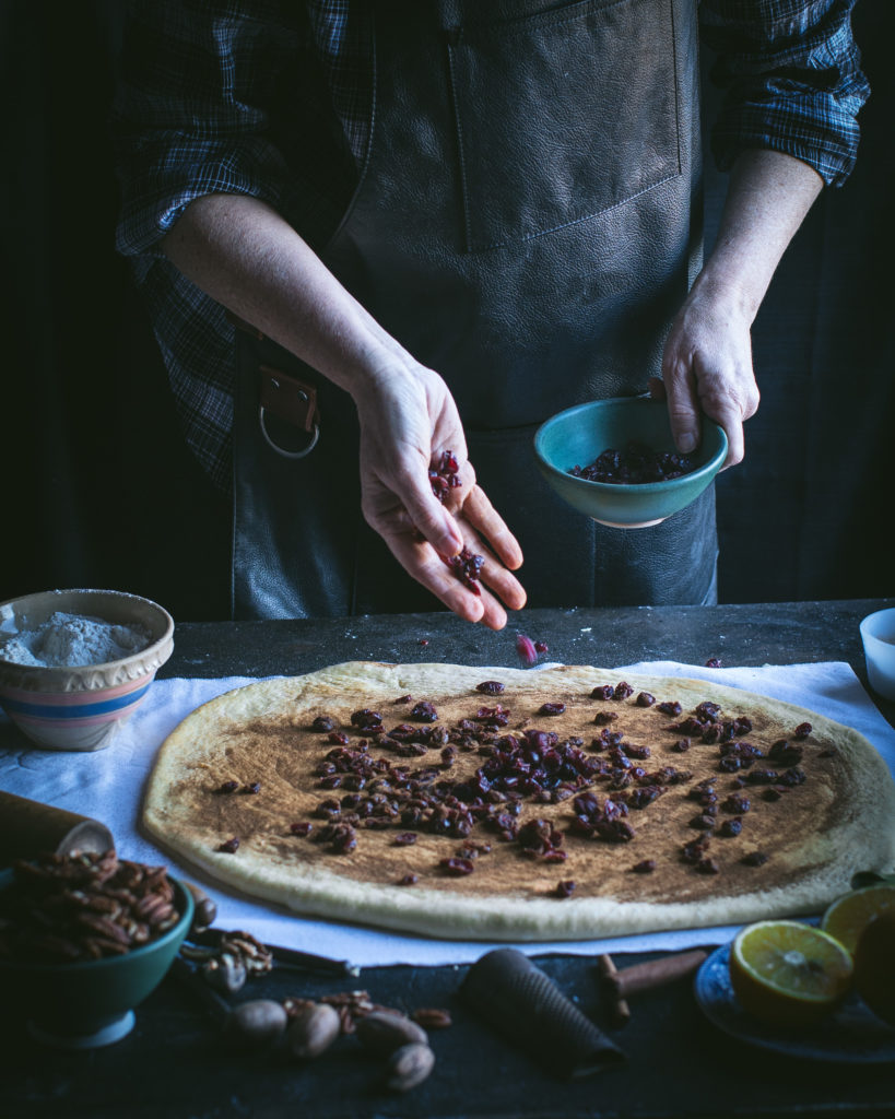 Scatter cherries over dough