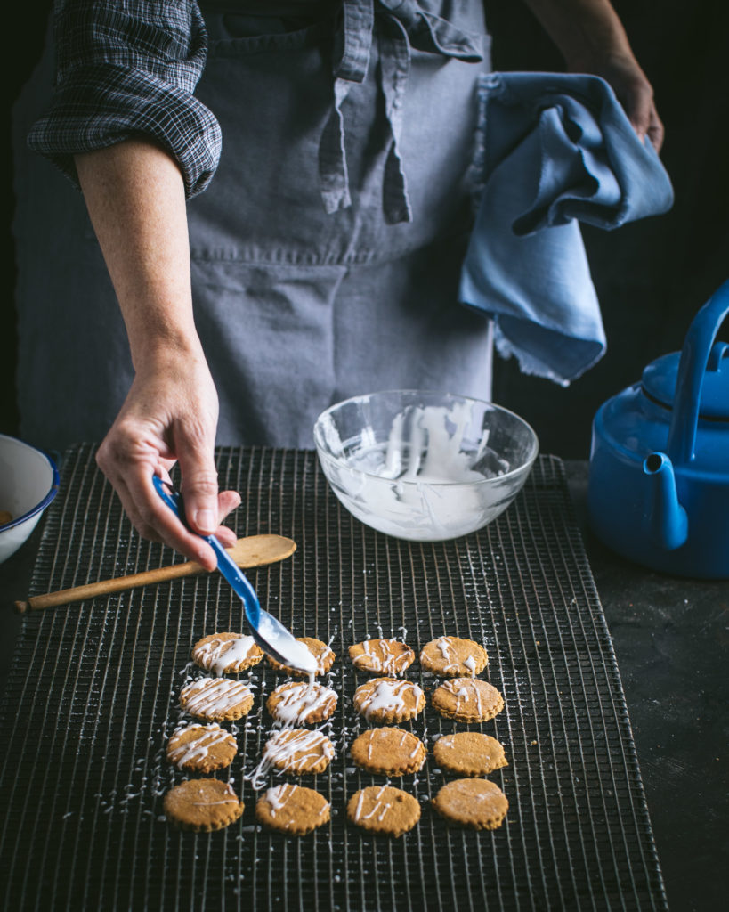 Drizzling glaze on Frosted Honey Ginger Snaps