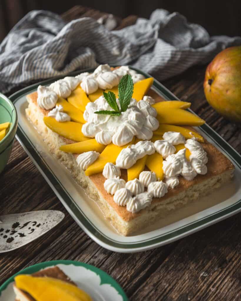 mango tres leches cake on a platter