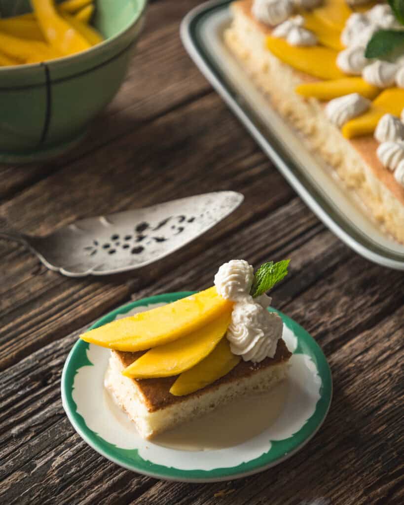 serving of mango tres leches cake on plate