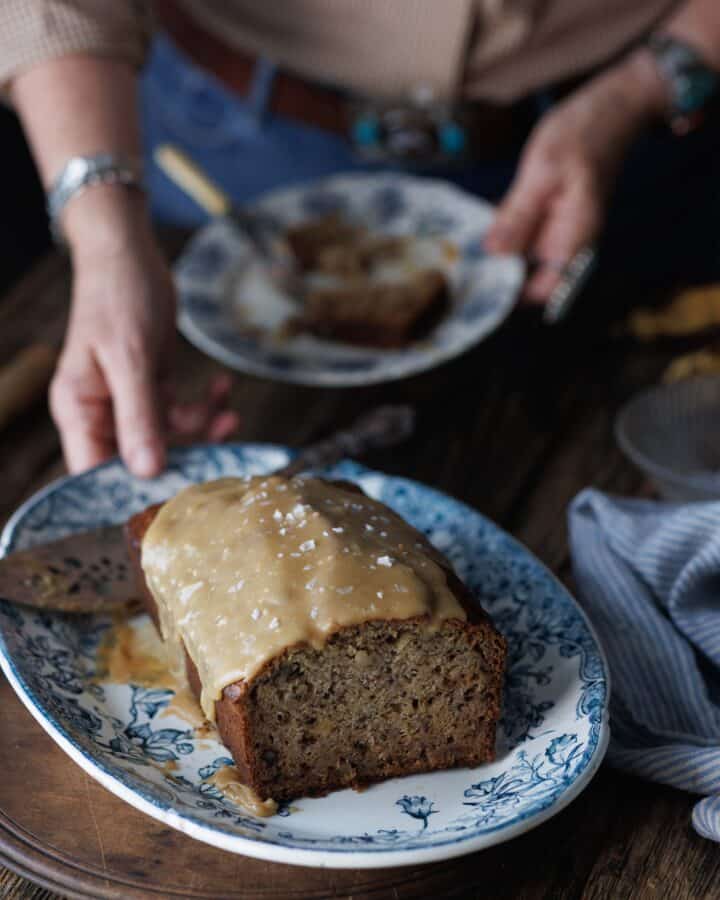 woman holding platter of banana bread