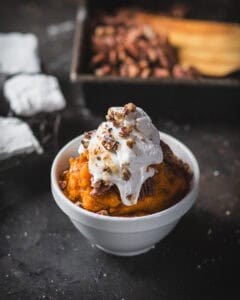 small dish of sweet potatoes with gooey marshmallows